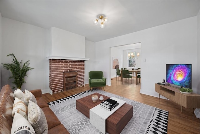 230 Linnview Ave, Carrick, PA 15210 - living room featuring a chandelier, wood finished floors, a fireplace, and baseboards