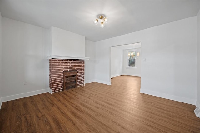 230 Linnview Ave, Carrick, PA 15210 - unfurnished living room featuring a chandelier, a fireplace, wood finished floors, and baseboards