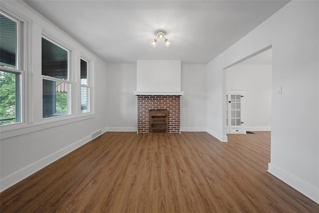 230 Linnview Ave, Carrick, PA 15210 - unfurnished living room featuring wood finished floors, baseboards, and a brick fireplace