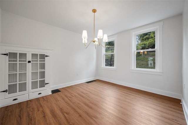 230 Linnview Ave, Carrick, PA 15210 - spare room featuring wood finished floors, a chandelier, and baseboards