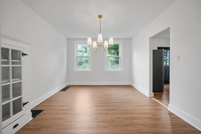 230 Linnview Ave, Carrick, PA 15210 - unfurnished dining area with a chandelier, wood finished floors, and baseboards