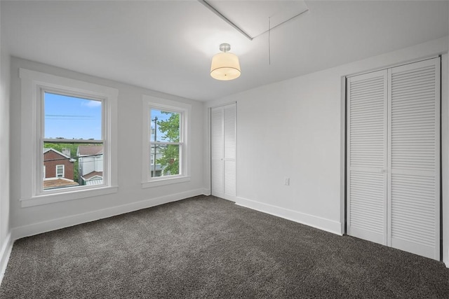 230 Linnview Ave, Carrick, PA 15210 - unfurnished bedroom featuring attic access, two closets, baseboards, and dark colored carpet