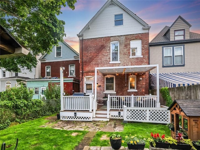 347 Spahr St, Shadyside, PA 15232 - back of house at dusk with brick siding and a wooden deck