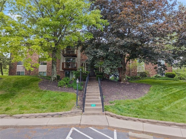 27711 Evergreen Run, North Fayette, PA 15126 - view of front of home with stairs, a front yard, and brick siding