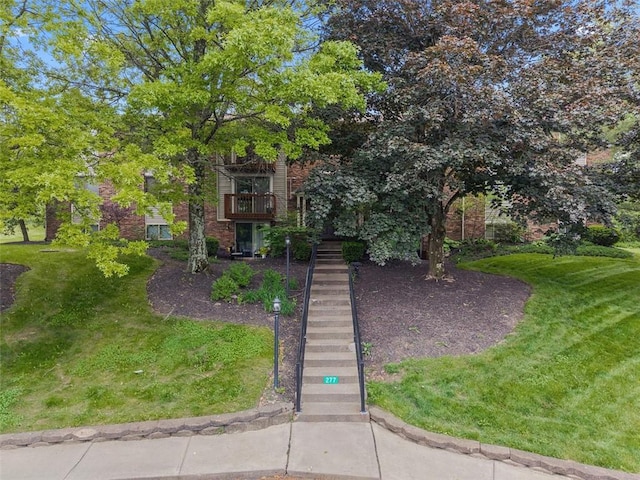27711 Evergreen Run, North Fayette, PA 15126 - obstructed view of property featuring brick siding, a front yard, and stairs