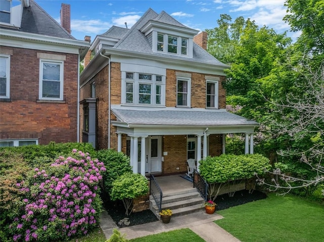 810 S Braddock Ave, Regent Square, PA 15221 - view of front of house featuring a chimney, a porch, brick siding, and a front lawn