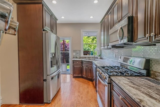 810 S Braddock Ave, Regent Square, PA 15221 - kitchen featuring stainless steel appliances, light wood finished floors, light stone counters, tasteful backsplash, and recessed lighting
