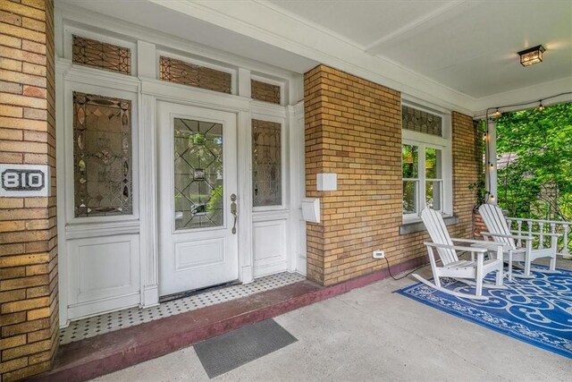 810 S Braddock Ave, Regent Square, PA 15221 - doorway to property featuring a porch and brick siding