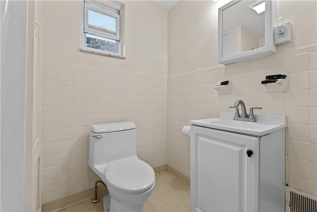 115 Frederick St, Mount Oliver, PA 15210 - half bathroom featuring tile walls, toilet, vanity, and a wainscoted wall