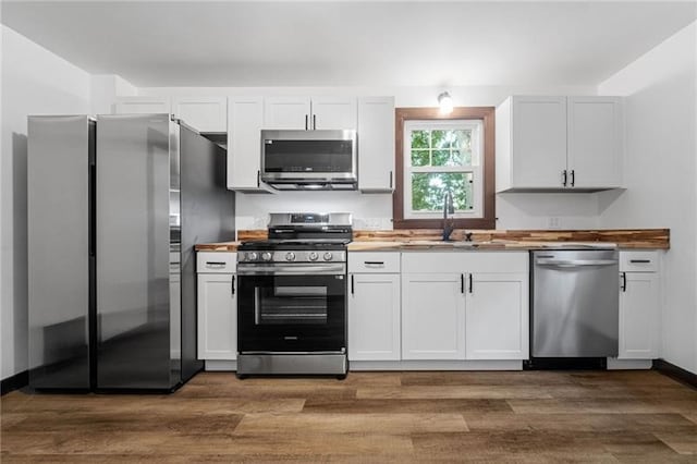 600 Howard St, Harmony Twp Bea, PA 15003 - kitchen featuring stainless steel appliances, a sink, dark wood-style flooring, and white cabinets