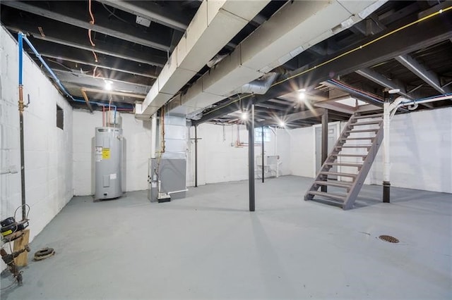 600 Howard St, Harmony Twp Bea, PA 15003 - below grade area with electric water heater, stairs, and heating unit