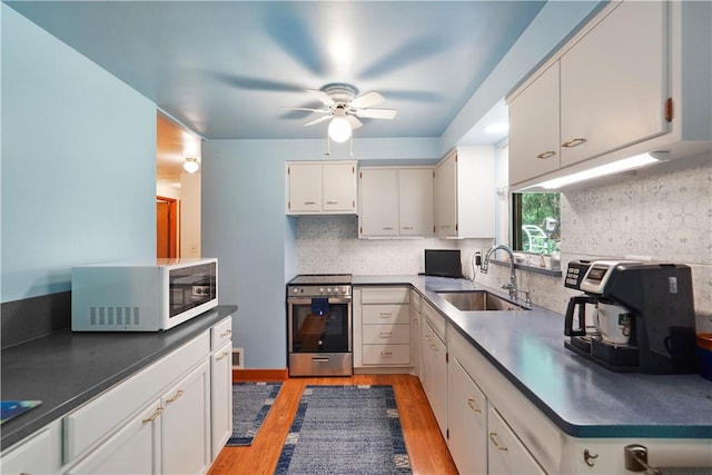 441 Wyndhurst Dr, Moon/Crescent Twp, PA 15108 - kitchen featuring white microwave, a sink, stainless steel electric range, light wood finished floors, and a ceiling fan