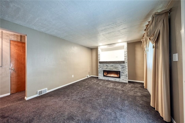 62 Spring St, Etna, PA 15223 - unfurnished living room with a large fireplace, dark carpet, a textured ceiling, and baseboards