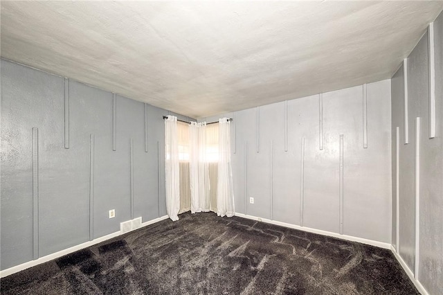 62 Spring St, Etna, PA 15223 - unfurnished bedroom featuring dark colored carpet, a decorative wall, and baseboards