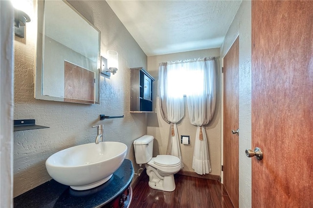 62 Spring St, Etna, PA 15223 - half bath with wood finished floors, a textured wall, a sink, and toilet