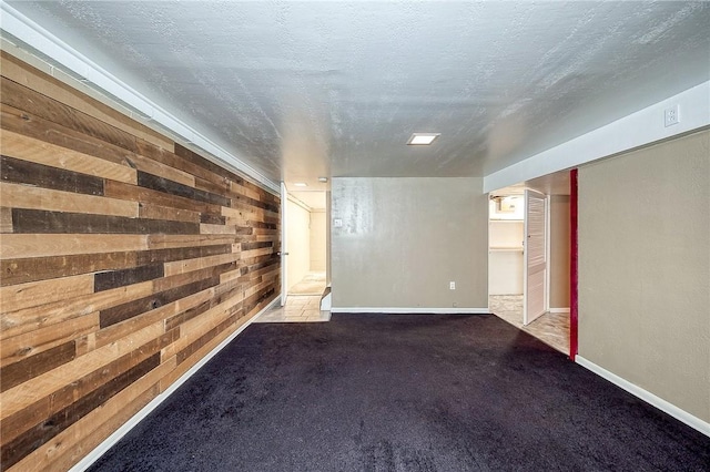 62 Spring St, Etna, PA 15223 - finished below grade area featuring carpet, baseboards, wooden walls, and a textured ceiling