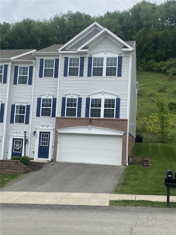 173 Rylie Dr, Lehigh Twp, PA 16037 - view of front of home with asphalt driveway, brick siding, a garage, and a front yard