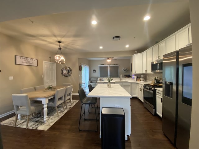 173 Rylie Dr, Lehigh Twp, PA 16037 - kitchen featuring appliances with stainless steel finishes, white cabinetry, dark wood finished floors, recessed lighting, and tasteful backsplash