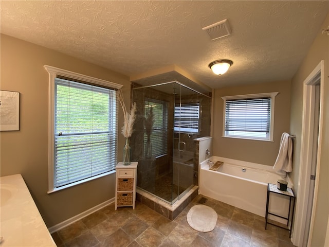 173 Rylie Dr, Lehigh Twp, PA 16037 - full bathroom featuring a bath, a shower stall, vanity, and a textured ceiling