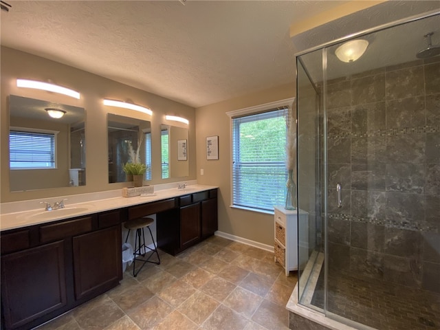 173 Rylie Dr, Lehigh Twp, PA 16037 - bathroom featuring double vanity, a shower stall, and a textured ceiling