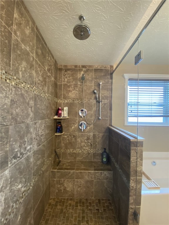 173 Rylie Dr, Lehigh Twp, PA 16037 - bathroom featuring a tile shower, a textured ceiling, and a bathtub
