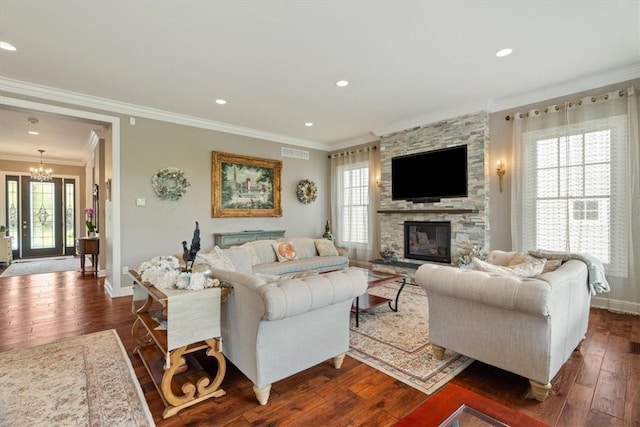 1690 Shelburne Ln, Squirrel Hill, PA 15217 - living room with a chandelier, ornamental molding, a stone fireplace, dark wood-type flooring, and baseboards