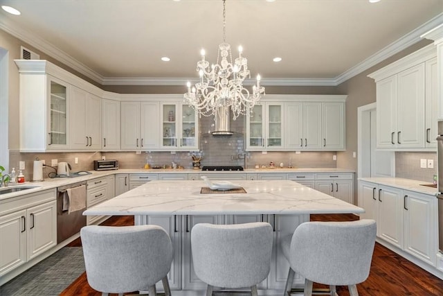 1690 Shelburne Ln, Squirrel Hill, PA 15217 - kitchen with stainless steel appliances, ventilation hood, a kitchen island, a chandelier, and decorative backsplash