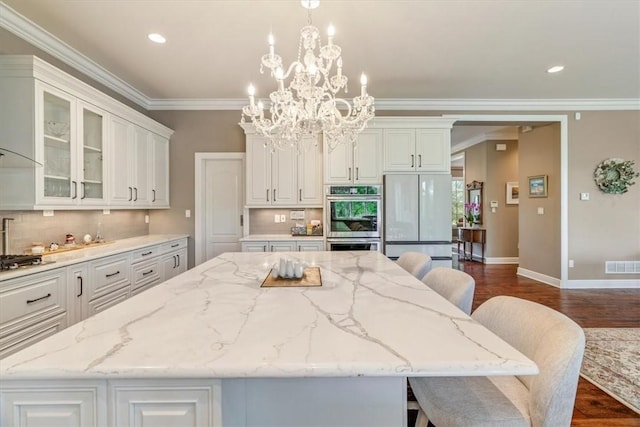 1690 Shelburne Ln, Squirrel Hill, PA 15217 - kitchen with appliances with stainless steel finishes, a center island, white cabinetry, tasteful backsplash, and recessed lighting