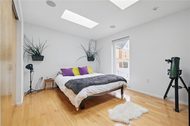 204 Bailey Ave, Mt Washington, PA 15211 - bedroom featuring a skylight, light wood-style floors, and baseboards