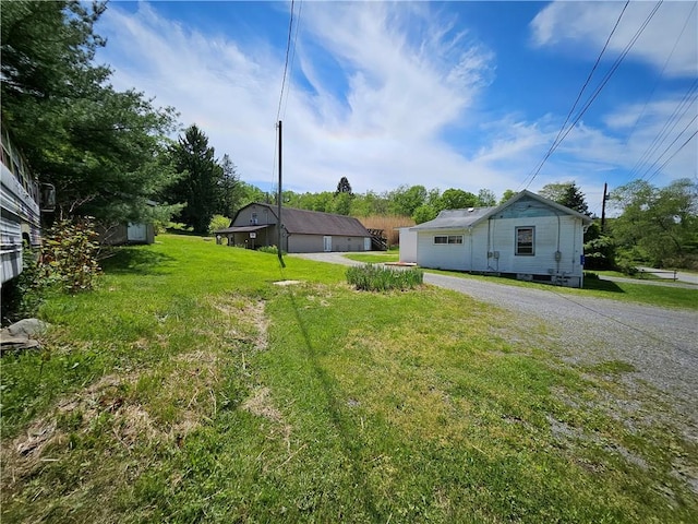 114 Leonard Rd, Washington Twp But, PA 16040 - view of grassy yard with a detached garage and an outdoor structure