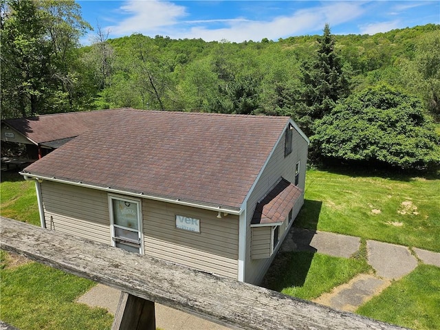114 Leonard Rd, Washington Twp But, PA 16040 - view of side of home with a view of trees, a lawn, and a shingled roof