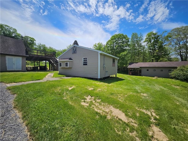 114 Leonard Rd, Washington Twp But, PA 16040 - back of house featuring stairway, a deck, and a lawn