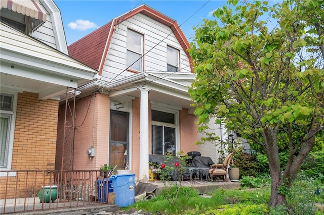 1318 Princess Ave, Beechview, PA 15216 - view of side of home with a gambrel roof, covered porch, and brick siding