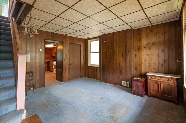1318 Princess Ave, Beechview, PA 15216 - carpeted empty room with stairway, wood walls, and a drop ceiling