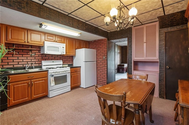1318 Princess Ave, Beechview, PA 15216 - kitchen with white appliances, dark countertops, brick wall, a chandelier, and light colored carpet