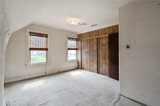1318 Princess Ave, Beechview, PA 15216 - unfurnished bedroom featuring wood walls, lofted ceiling, multiple windows, carpet, and a closet