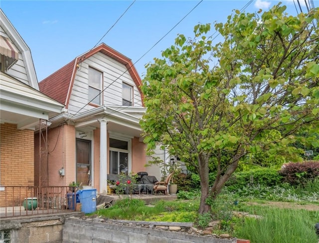 1318 Princess Ave, Beechview, PA 15216 - view of front of house with a gambrel roof, a porch, and brick siding