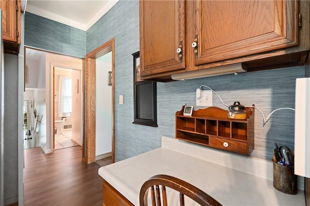 2418 Graceland Rd, Neshannock Twp, PA 16105 - kitchen featuring brown cabinets, light countertops, dark wood-type flooring, and baseboards