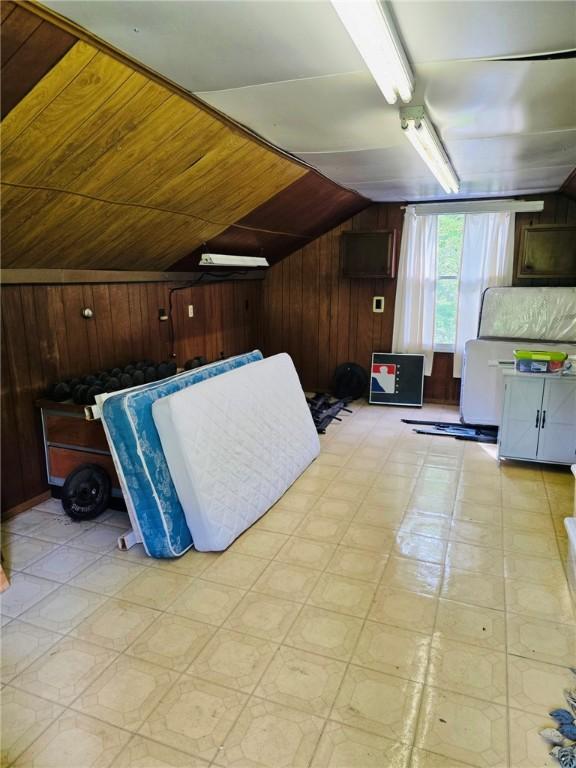 2418 Graceland Rd, Neshannock Twp, PA 16105 - bonus room with lofted ceiling, wood walls, and light flooring