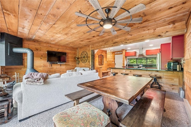 20 Craighead Dr, Hidden Valley, PA 15502 - carpeted dining area with wood ceiling, wood walls, a sink, a wood stove, and ceiling fan
