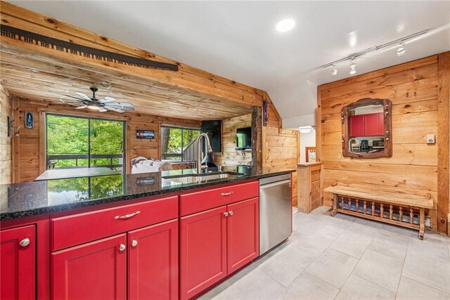 20 Craighead Dr, Hidden Valley, PA 15502 - kitchen featuring red cabinets, stainless steel dishwasher, a sink, wooden walls, and a ceiling fan