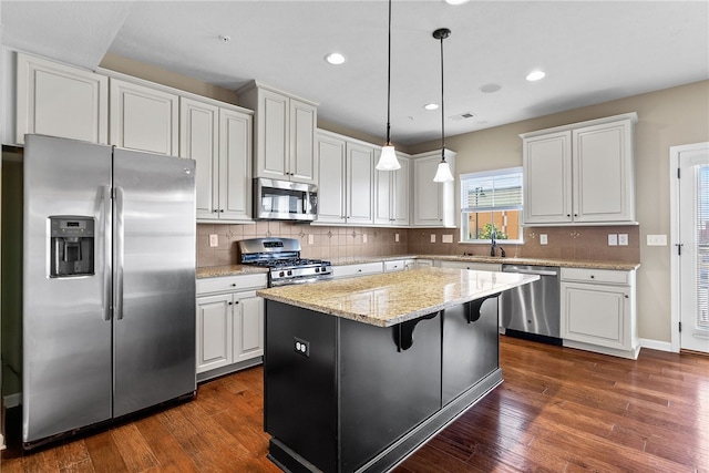 876 Beacon Ln, Mccandless, PA 15237 - kitchen with appliances with stainless steel finishes, a kitchen island, white cabinets, dark wood-type flooring, and recessed lighting