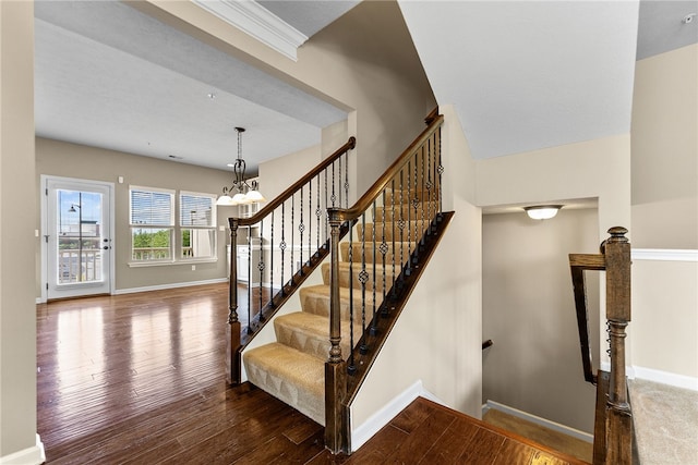 876 Beacon Ln, Mccandless, PA 15237 - staircase featuring wood finished floors, baseboards, and a chandelier