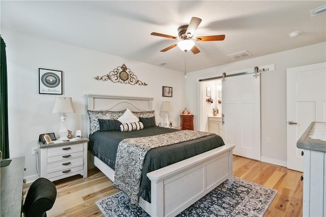 153 Olivia Dr, Center Twp Bea, PA 15061 - bedroom with a barn door, light wood finished floors, ceiling fan, and ensuite bathroom