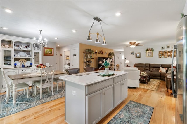 153 Olivia Dr, Center Twp Bea, PA 15061 - kitchen with light wood-type flooring, a center island, a chandelier, ceiling fan, and hanging light fixtures