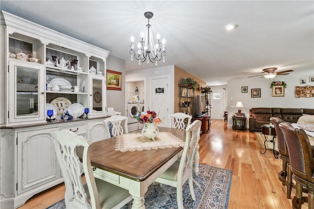 153 Olivia Dr, Center Twp Bea, PA 15061 - dining area with washer / dryer, a chandelier, light wood-style flooring, and a ceiling fan