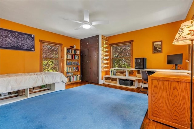 439 Pleasant Hill Rd, Allegheny Twp Wml, PA 15656 - bedroom with wood finished floors, multiple windows, an office area, and a ceiling fan