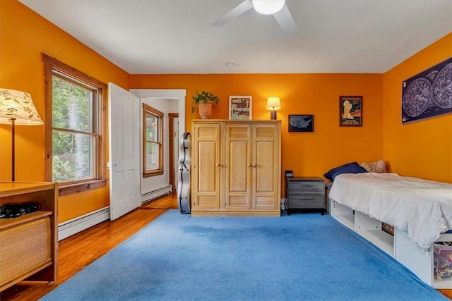 439 Pleasant Hill Rd, Allegheny Twp Wml, PA 15656 - bedroom featuring a baseboard radiator, a ceiling fan, and wood finished floors