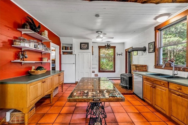 439 Pleasant Hill Rd, Allegheny Twp Wml, PA 15656 - kitchen featuring freestanding refrigerator, a sink, a wood stove, dishwasher, and open shelves