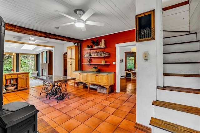 439 Pleasant Hill Rd, Allegheny Twp Wml, PA 15656 - dining area with a ceiling fan, light tile patterned floors, stairs, beam ceiling, and a baseboard radiator